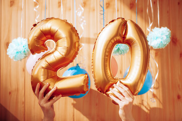 Happy twentieth birthday with golden number twenty 20 balloons and colorful decorations,...