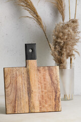 Wooden cutting board on light background