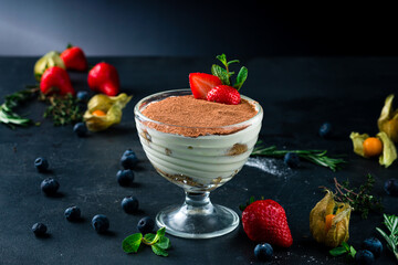 luxurious dessert Tiramisu in a glass and strawberries