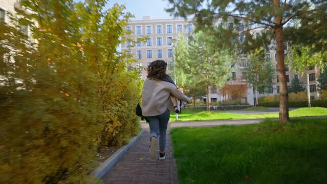 Handheld Authentic And Immersive Shot Of Young Woman Run Towards Class Or College Inside University Campus. Concept Late For Work Or Classes