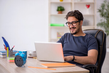 Young male designer working in the office