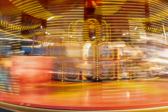 Long exposure of a colourful spinning carousel fairground ride