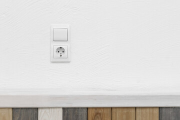 Socket and light off turn on button on the background of the switch white wall modern interior of the house