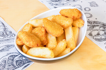 Fried nuggets served in a kebab restaurant with French fries on the side