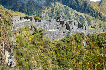 Fototapeta na wymiar Sayaqmarka Ruins on the Inca Trail to Machu Picchu, Peru. There are over 100 steps to climb in order to reach the majestic hillside ruins.