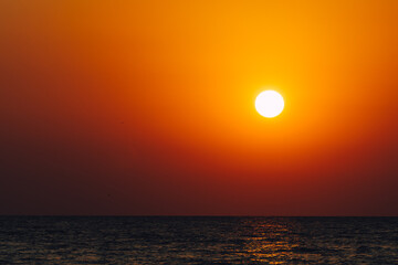 Dramatic vibrant sun over ocean