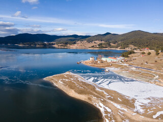 Aerial winter view of Dospat Reservoir covered with ice, Bulgaria
