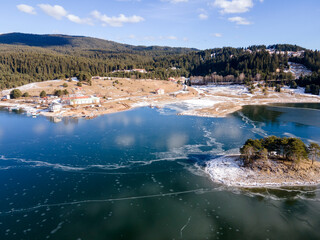 Aerial winter view of Dospat Reservoir covered with ice, Bulgaria