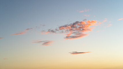 Abstract view of isolated clouds in sky at sunset