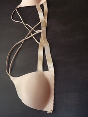 beige bra with front closure on black background. High quality photo