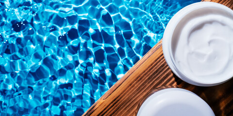 White plastic open jar of facial and body cream gel on wooden board in water sculpt anti aging treatment. Banner, text