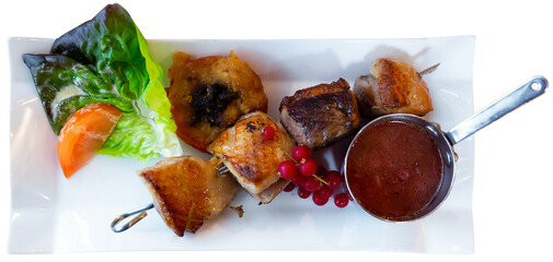 French dish - duck breast on a skewer with red currant sauce. Isolated over white background