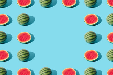 Arranged watermelon and the half on a blue pastel background. Minimal pattern and design. Copy...
