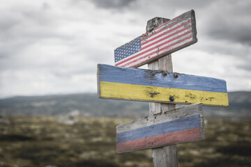 usa, ukraine and russia national flags on wooden signpost outdoors. to simulate the conflict in ukraine, donetsk luhansk. - obrazy, fototapety, plakaty