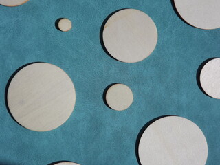 wooden circles of different diameters on blue suede. High quality photo
