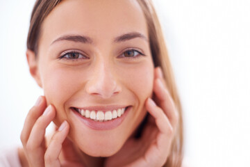 Youthful radiance. A young woman smiling at the camera - closeup.