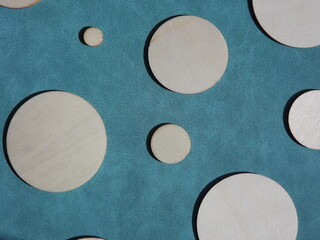 wooden circles of different diameters on blue suede. High quality photo