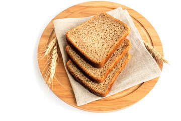 Sliced fresh wheat-rye bread for sandwiches on a light-colored kitchen board.White background.