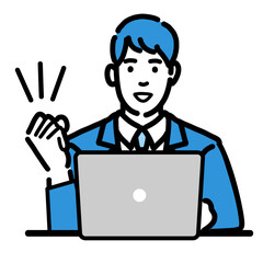 ラップトップの前で笑顔でガッツポーズをしているスーツを着た若い男性
