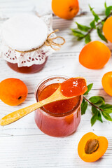 Apricot Jam with Fresh Summer Apricot on White Wooden Background. Selective focus.
