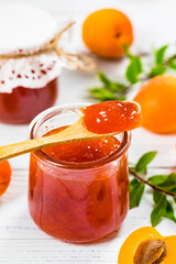 Apricot Jam with Fresh Summer Apricot on White Wooden Background. Selective focus.