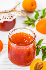 Apricot Jam with Fresh Summer Apricot on White Wooden Background. Selective focus.