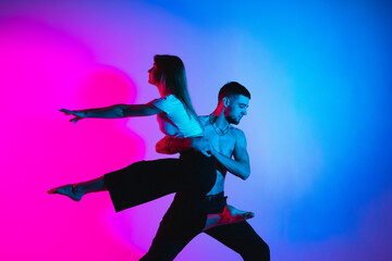 Fototapeta na wymiar Gymnastics support. A man and a girl perform an acrobatic exercise
