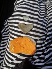 Heart shape of rock between other stones on a cloth