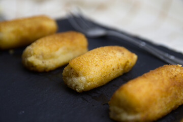 Close-up of a portion of homemade croquettes next to a fork