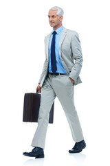 Hes got purpose in his stride. Full length studio shot of a mature businessman walking with a briefcase isolated on white.