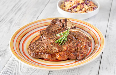 Pan-fried T-bone steak with fresh rosemary