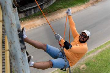 Man practicing rappel on a pedestrian walkway.