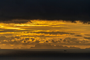 Dramatic sunset over the sea water on the island of Koh Phangan, Thailand. Travel and nature concept