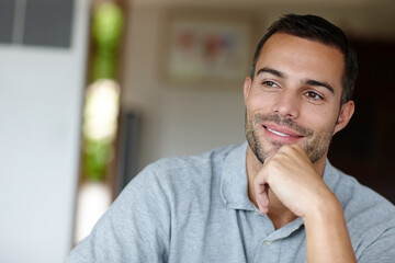 What a gorgeous guy. Shot of an attractive, smiling young man at home.