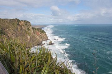 A small rocky outcrop at Mercer Bay, West Coast Beach near Auckland, New Zealand.