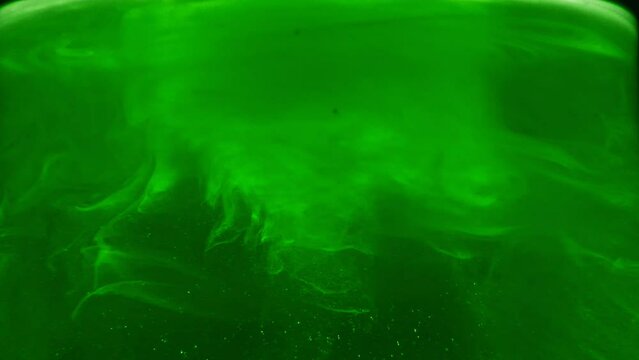 Paint fall into water which is twist. Spin acrylic ink drip into liquid. Visual effect bullet time, frozen moment, flow motion. Cloud fraction of color is spray drop. Slow motion cosmic video magic.