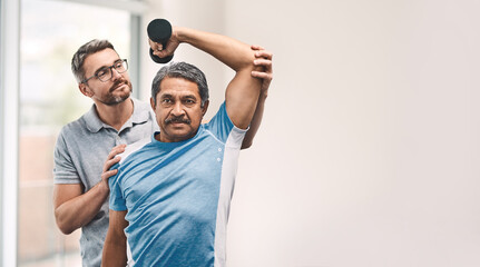 Proper technique is the main focus. Shot of a senior man exercising with dumbbells during a...