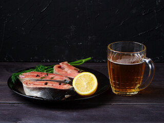 Salmon and beer on wooden background