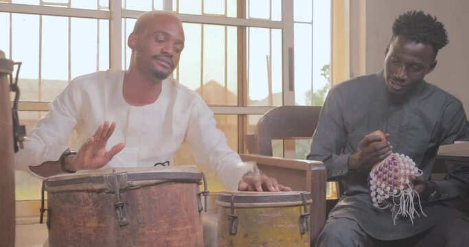 smiling men playing African instruments