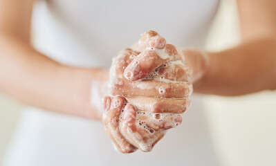 Keep clean and safe from germs. Closeup shot of a woman washing her hands with soap.