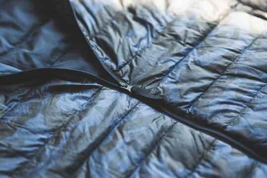 Close up of zip on blue camouflage  down jacket