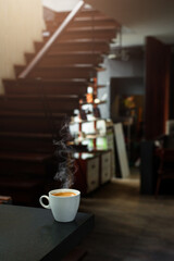 Cup of espresso coffee on black table