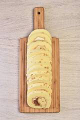 Salted roll cake stuffed with dried shredded pork and cream on the wooden cutting board
