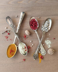 Antique spoons with spices. Nutmeg, pepper, turmeric. Cutlery.