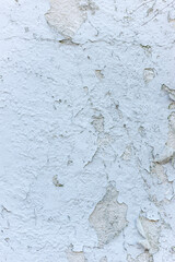 Cracked and peeling white paint on a wall