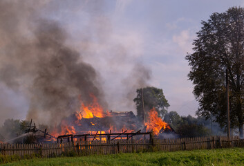 Fototapeta na wymiar A fire in the village. Burning wooden houses in the village of Rantsevo, Tver region. 