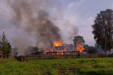 Fototapeta na wymiar A fire in the village. Burning wooden houses in the village of Rantsevo, Tver region. 