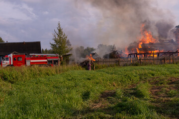 Obraz na płótnie Canvas A fire in the village. Burning wooden houses in the village of Rantsevo, Tver region. 