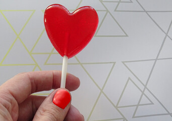 A heart-shaped lollipop in your hand