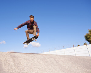 Perfecting his tricks. A young man doing tricks on his skateboard at the skate park. © Mariusz S/peopleimages.com